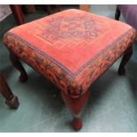 A carved oak footstool with kilim tapestry