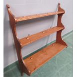 An oak waterfall bookshelf, with three graduated s