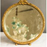 A giltwood circular table mirror with floral carved decoration and bevelled edge mirror.