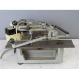 An engraving machine with ancillaries and materials.