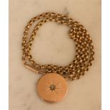 A 9ct gold locket and chain, the circular locket with starburst to the centre, 12.7g.