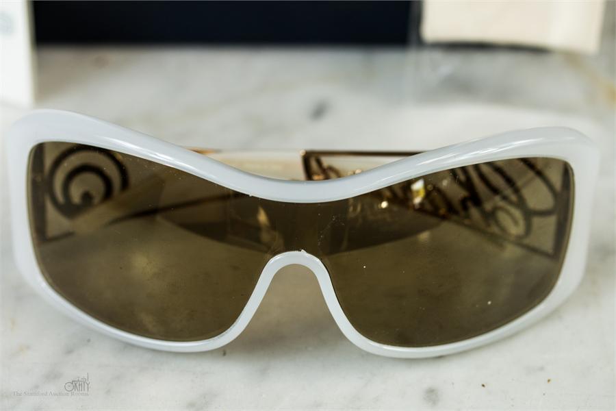 A pair of Chopard sunglasses, no. CH441873, togeth