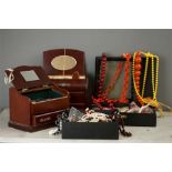 A large quantity of costume jewellery, to include two mahogany jewellery boxes, pearl necklaces,