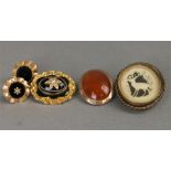 Three Victorian brooches: a mourning brooch with a star set with seed pearls centring an oval