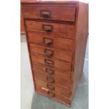 An antique cabinet with nine drawers containing various tools etc.