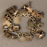 A silver charm bracelet, with twenty charms, 2.18toz.