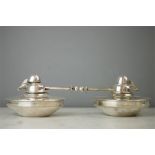 A pair of silver plated oil burners, early 20th century.