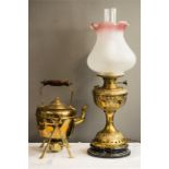 A Victorian brass oil lamp and a a brass kettle on oil burner and stand.