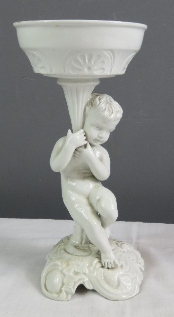 A white ceramic figure of a cherub raising a dish. - Image 21 of 30