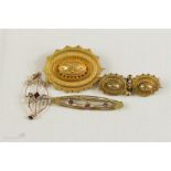 A 9ct gold sweetheart brooch with pink paste stones, a Victorian mourning brooch, and a 9ct gold