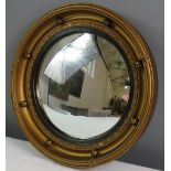A Regency style convex 'port hole' mirror.