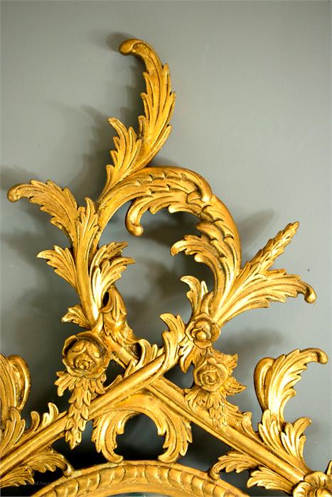 A giltwood oval wall mirror, carved with Rococo style scrollwork. - Image 2 of 3