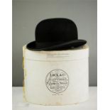 A Lock & Co. Hatters black bowler hat with original hat box bearing makers label.