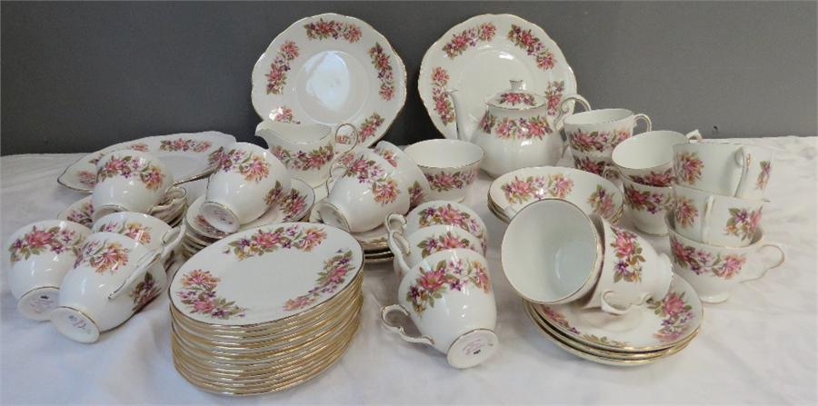 A Colclough bone china tea service, pattern no 8561, comprising tea pot, sugar bowl, milk jug, 19