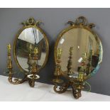 A pair of gilt brass wall sconces, with oval mirrored backs and two branches 37 by 25cm, together