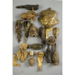 A group of gilt brass cast fittings, including face masks, sabots and finials etc.