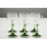 A set of six greens stemmed wine glasses with engraved stars to the cups.