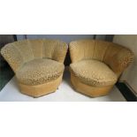 A pair of retro tub chairs with fan-form backs, raised on ceramic castors.