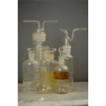 A group of laboratory chemistry glass bottles, one