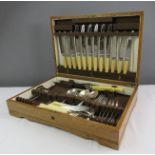 An oak cased canteen of cutlery.