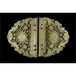 A 19th century mother of pearl carved buckle, pierced and carved with scrollwork decoration and