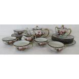 A Chinese porcelain tea set with geisha girls to the bases.