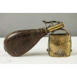 A 19th century leather and brass powder flask together with a brass cow bell.