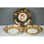 A pair of Derby plates with yellow painted flowers decorating the edges, highlighted with gold,