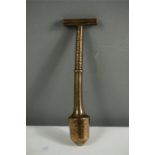 A 19th century bronze tool with T bar handle.