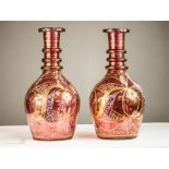 A pair of Bohemian cranberry glass vases, circa 1900, with engraved and gilded decoration.