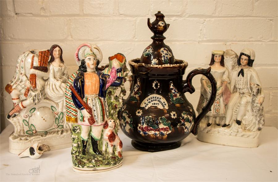 Three Staffordshire flatback figure groups and a Bargeware tea pot 'A present to Mr & Mrs Weston,