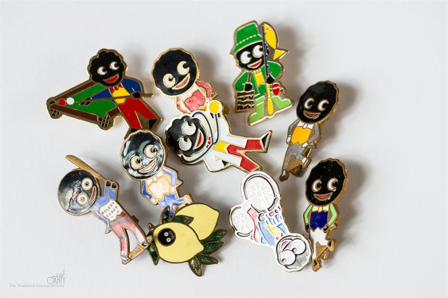 A group of ten Robinsons Golly badges.