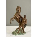 A bronze patinated metal warrior and horse.