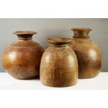 Three treen gourd type vessels, hand turned, of varying form.