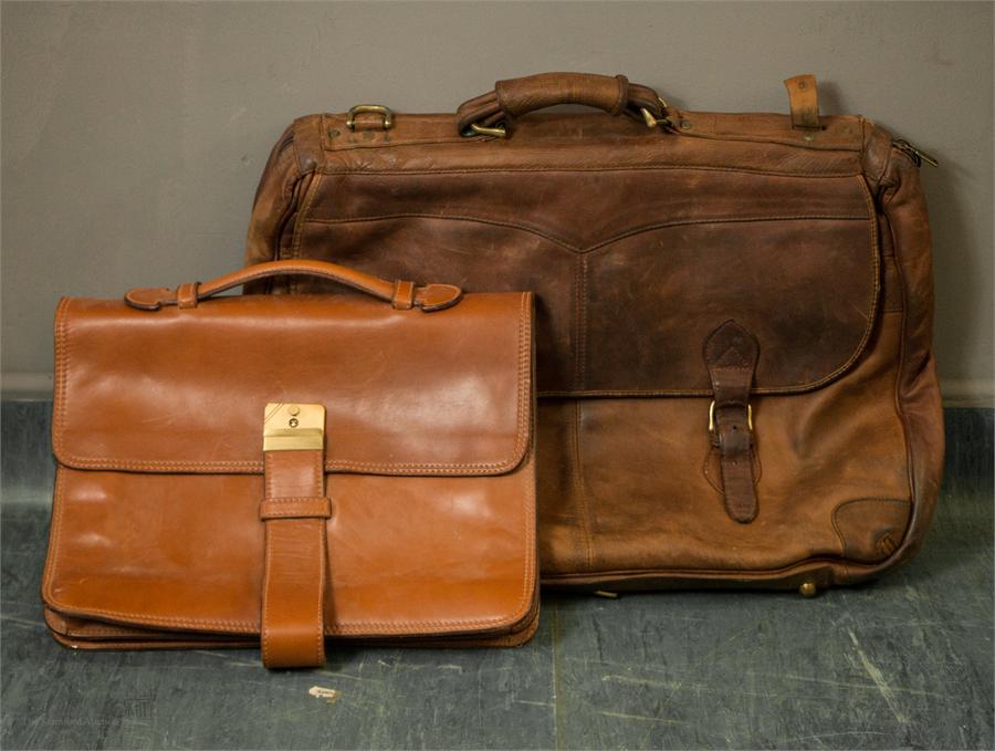 A large leather satchel with two straps, together with a smaller leather satchel.