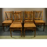 A set of six rustic hardwood dining chairs with solid seats, with iron brackets.