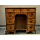 A George II mahogany kneehole desk with two slim drawers above a frieze drawer and cupboard