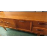 A teak retro sideboard with shaped handles.