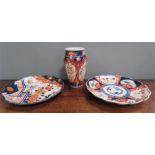 Two Imari plates and a similar baluster vase.