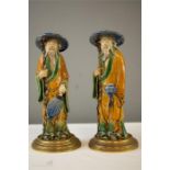 A pair of Chinese stoneglazed figures, with coloured glaze, 29cm high.