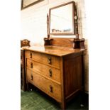 An oak dressing table with three drawers and mirrored back.