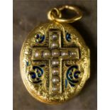 An oval gold locket engraved with scrollwork and retaining residual blue enamelling, the cross and