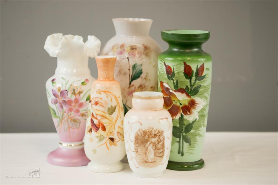 A group of Victorian coloured glass vases, decorated with flowers.