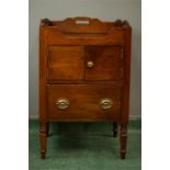 A 19th century mahogany night table with shaped top rails, two doors above two cupboard doors, and a