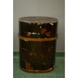 An antique Chinese black lacquered cylindrical form box with carrying handles, the lid painted