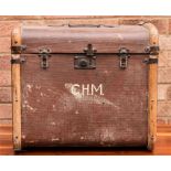 A small travelling trunk, with straps and painted with the initials CHM.