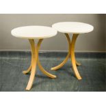 Two beech tables with white circular tops.