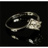 An 18ct gold and four stone diamond ring, size N, 1.7g.