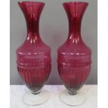 A pair of cranberry glass vases of baluster form.