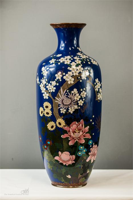 A 19th century Chinese cloisonne vase, depicting a group of peonies, chrysanthemum, and prunus